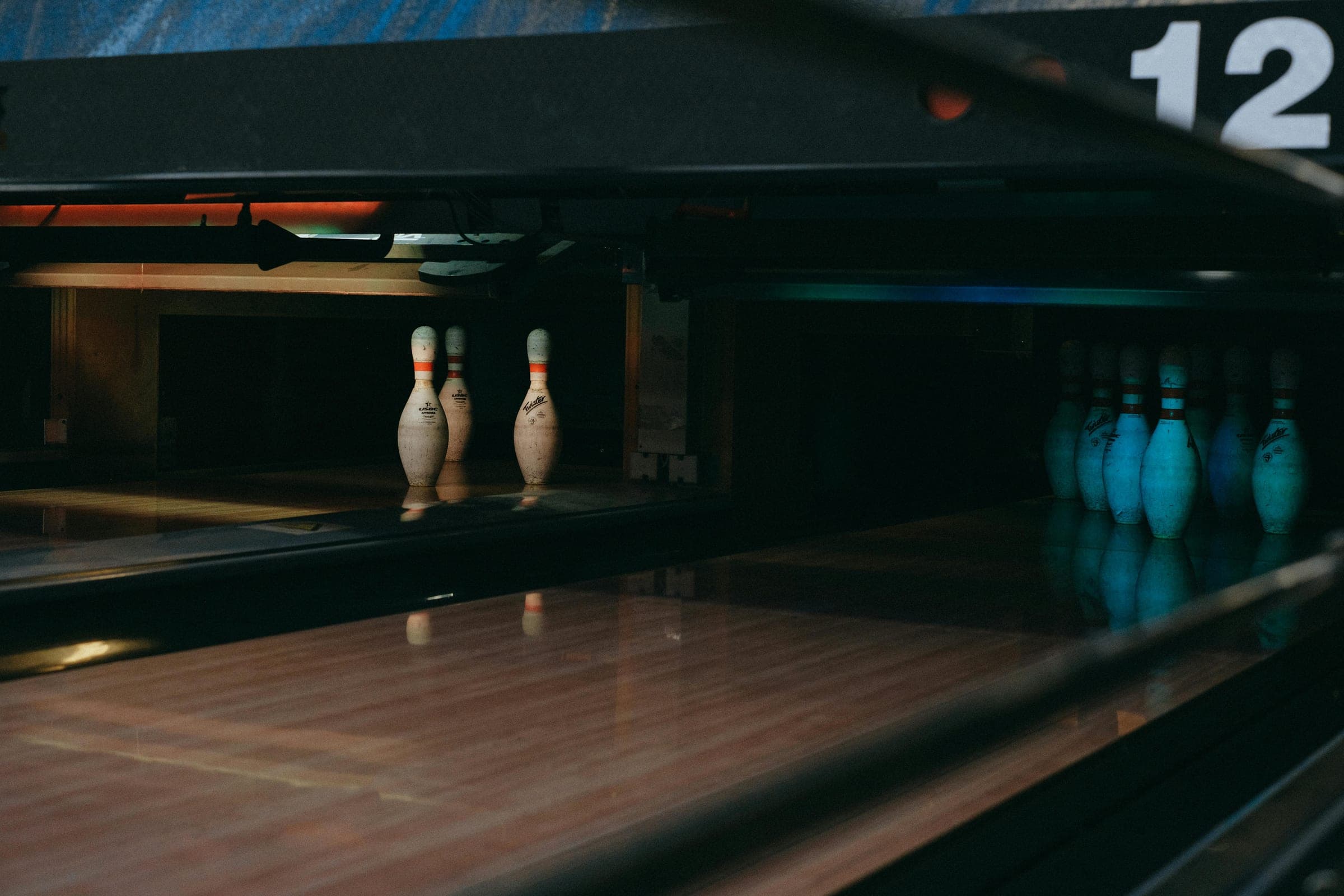 Pins at the end of a dark bowling lane