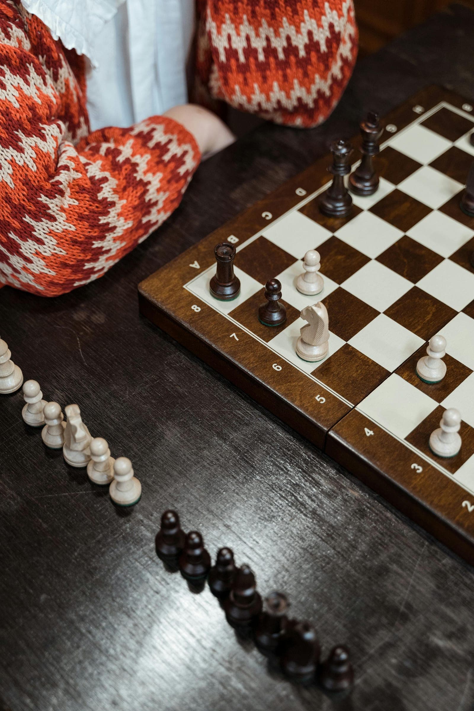 A chess game in progress on a wooden board