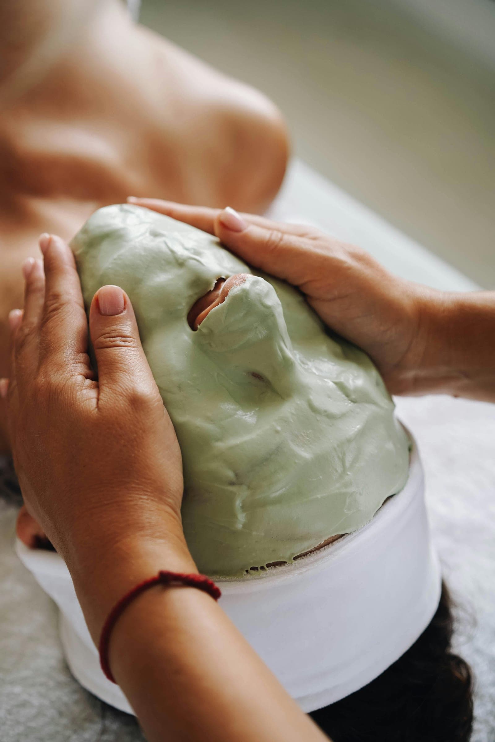 A clay face mask being applied