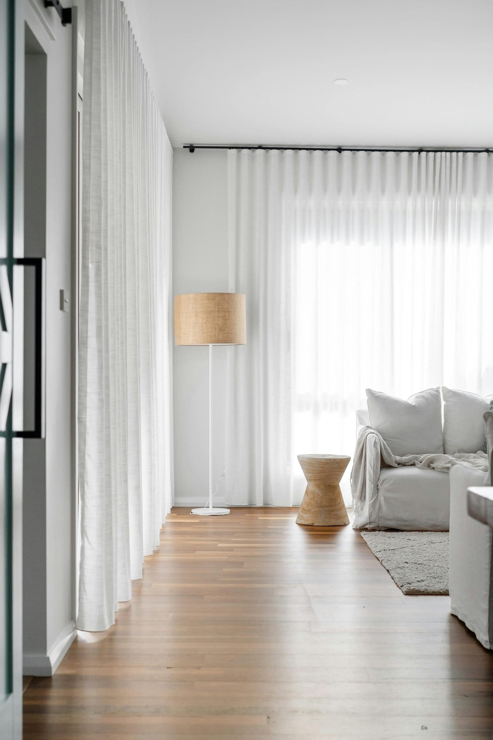 A quiet lounge corner with a sofa and floor lamp