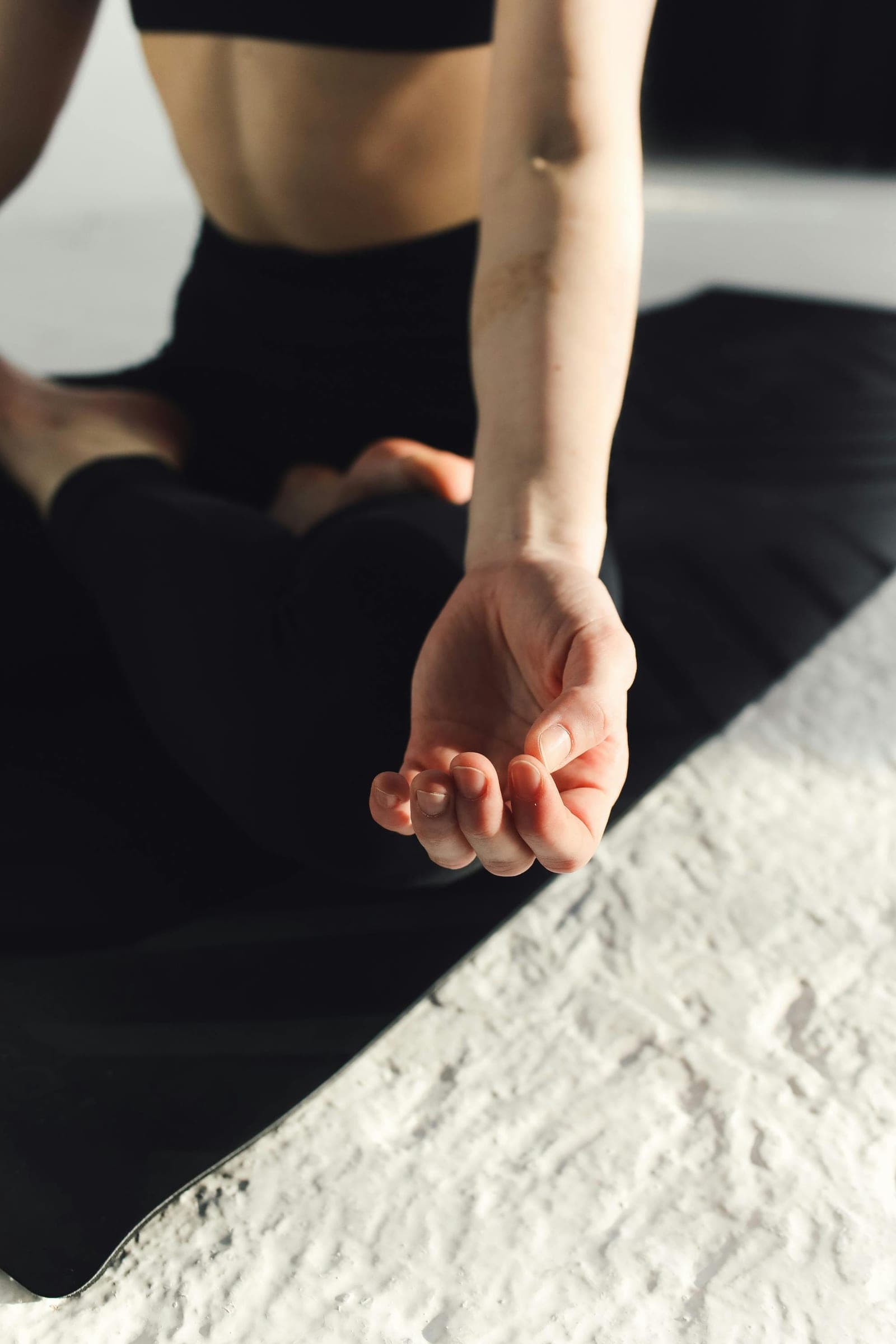 A hand resting in a meditation pose