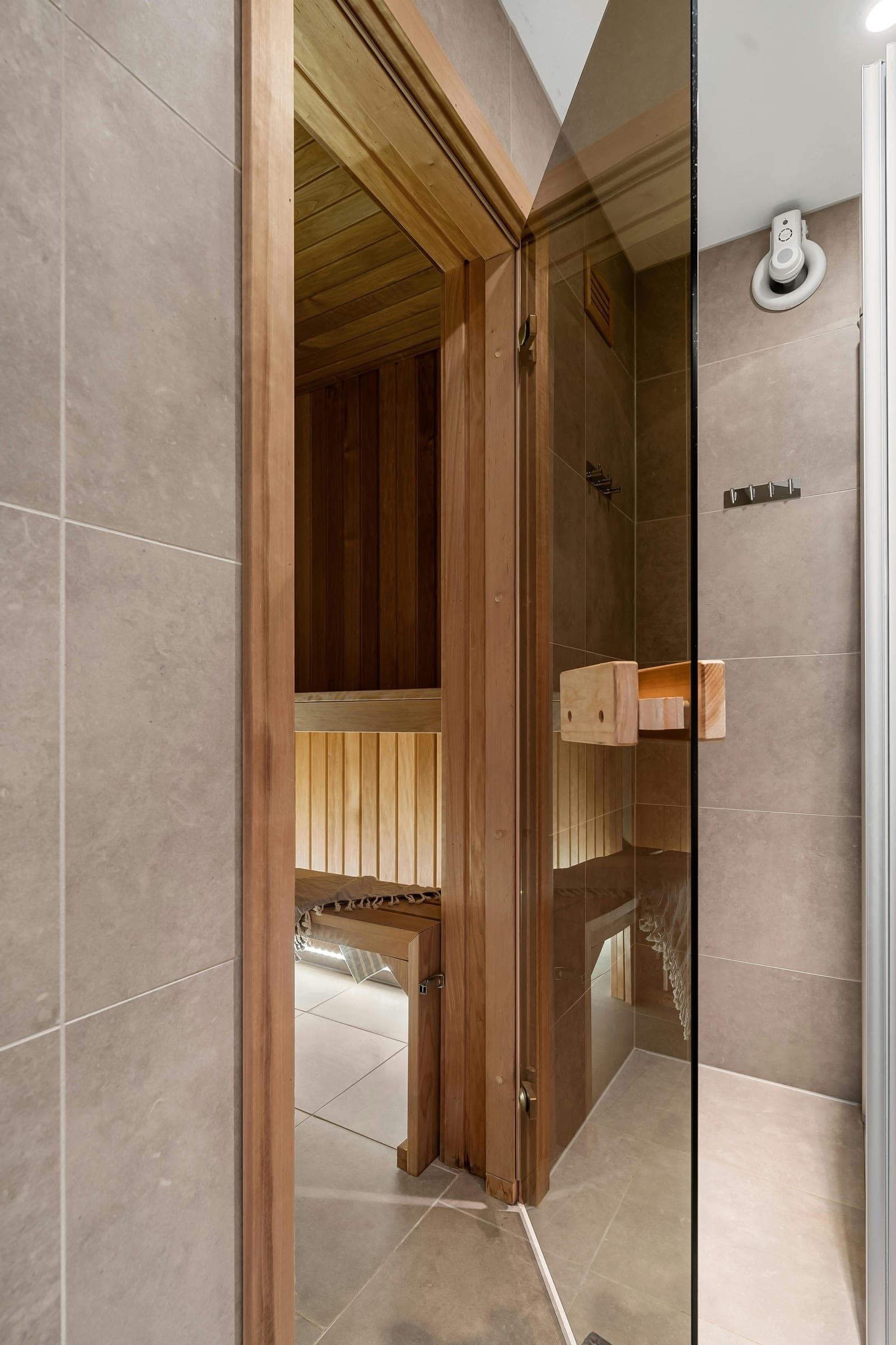 A timber sauna behind a glass door