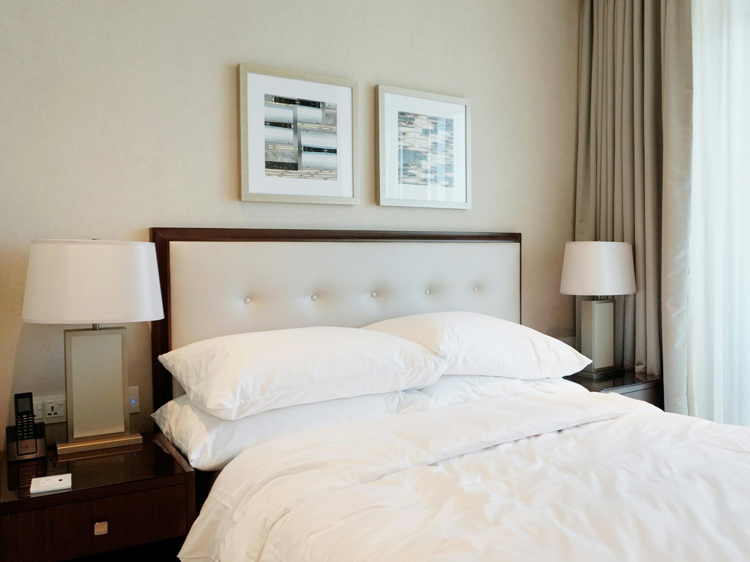A calm, light-filled room with a made bed