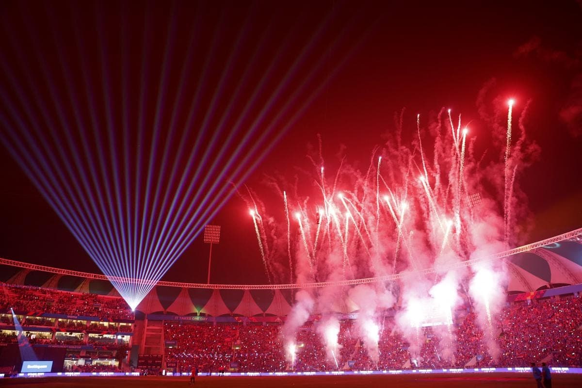Fireworks and lasers over a stadium at night
