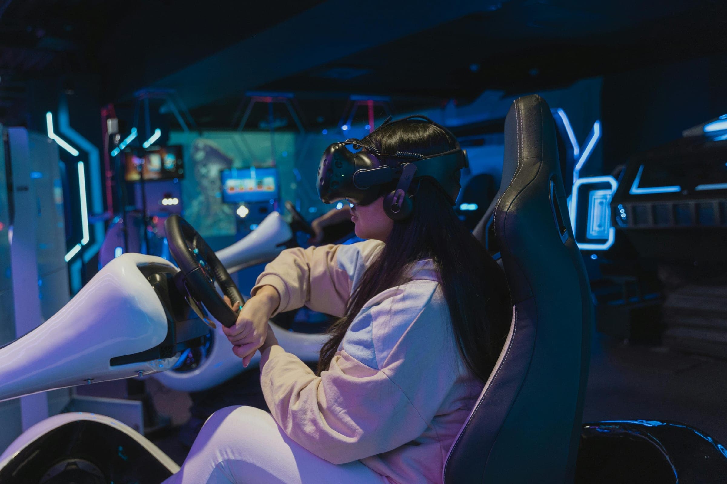 A player racing in a VR simulator seat